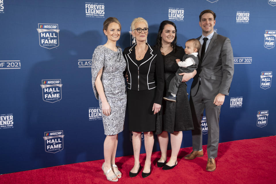 Julie Stefanik, second from left, widow of NASCAR Hall of Fame inductee Mike Stefanik, poses for photos prior to the induction ceremony Friday, Jan. 21, 2022, in Charlotte, N.C. (AP Photo/Matt Kelley)