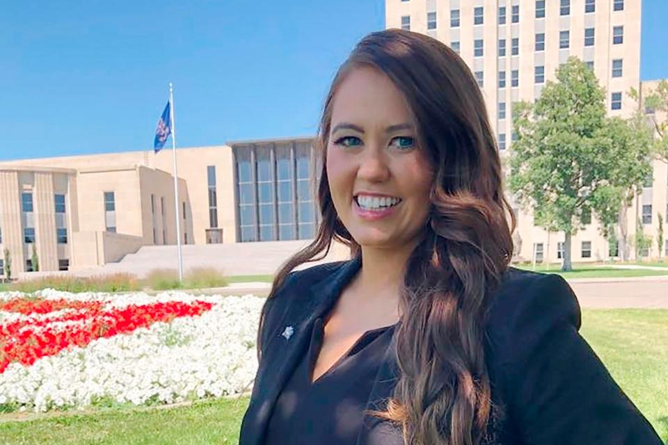 Cara Mund poses for a photo in front of the state Capitol in Bismarck, N.D. on Wednesday, Aug. 10, 2022. The former Miss America Mund says her concern about abortion rights prompted her to launch her independent bid for the U.S. House in her home state. Mund would face an uphill battle in deeply conservative North Dakota, but told The Associated Press that the U.S. Supreme Court's ruling to overturn a constitutional right to abortion was "just a moment where I knew we need more women in office."