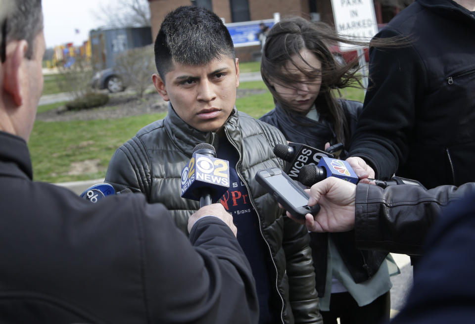 William Tigre talks to reporters at a crime scene where the bodies of four men were found in Central Islip, N.Y., Thursday, April 13, 2017. Tigre said an acquaintance told him Wednesday night that his 18-year-old brother, Jorge, was one of the victims. Police say they're investigating the disappearance of Jorge Tigre, but would not comment on whether the teenager was among those killed. (AP Photo/Seth Wenig)