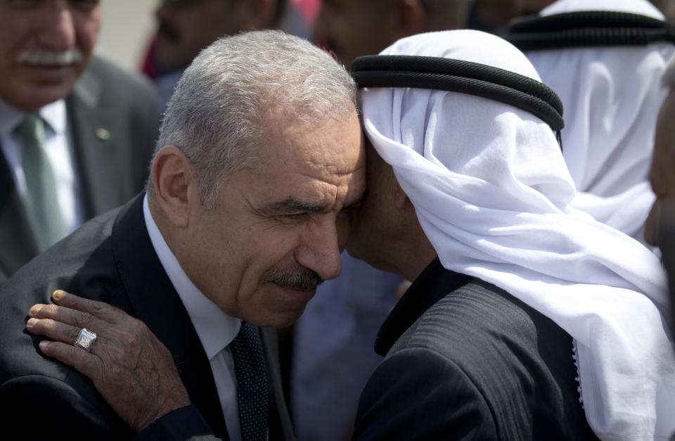 Palestinian Prime Minister Mohammed Shtayyeh, left, arrives for a cabinet meeting in the Jordan Valley village of Fasayil, Monday, Sept. 16, 2019. Israeli Prime Minister Benjmin Netanyahu has vowed to annex "all the settlements" in the West Bank in a bid to whip up support as Israelis head to the polls Tuesday in the second election this year. To protest that announcement, the Palestinian Authority held a Cabinet meeting in the Jordan Valley village of Fasayil on Monday, a day after Israel's Cabinet met elsewhere in the valley. (AP Photo/Majdi Mohammed)