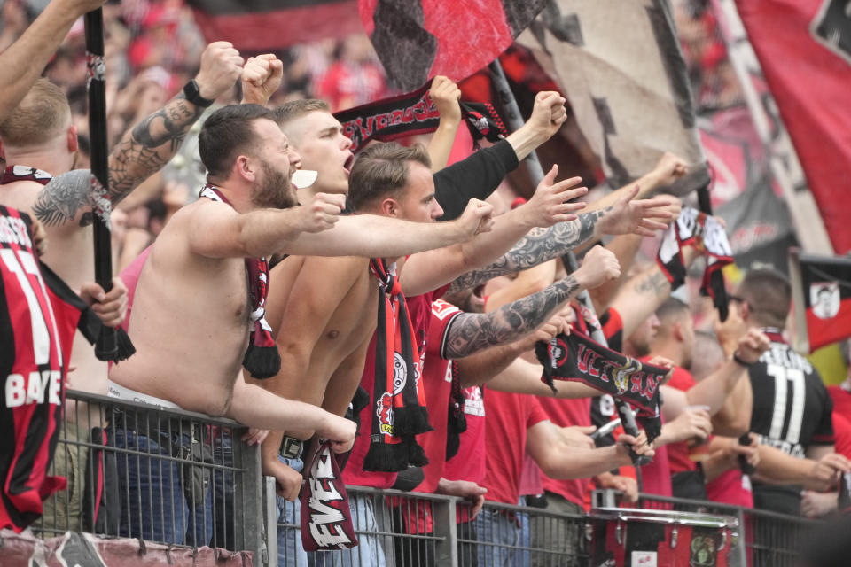 Leverkusen's fans support their team during the German Bundesliga soccer match between Bayer Leverkusen and FC Augsburg at the BayArena in Leverkusen, Germany, Saturday, May 18, 2024. (AP Photo/Martin Meissner)