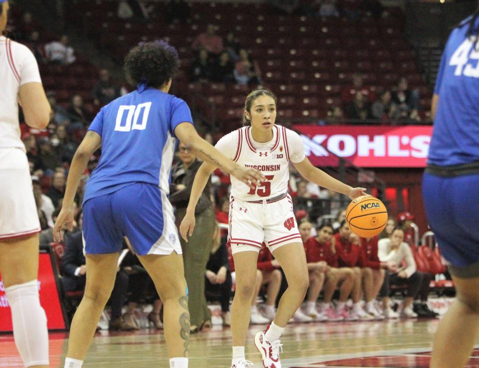 Then with Wisconsin, Sania Copeland surveys the floor as Saint Louis' Kyla McMakin defends during a WNIT quarterfinal game at the Kohl Center in Madison, Wisconsin on April 1, 2024.