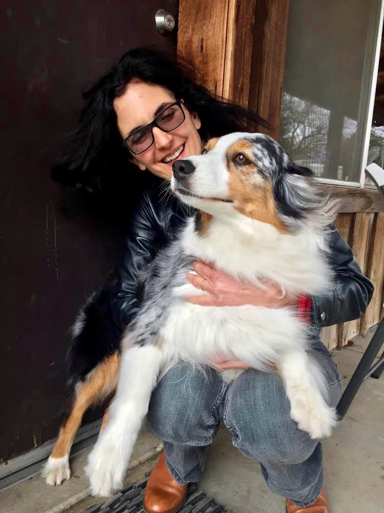 Author Maria Goodavage greets an Australian shepherd named Stewie.