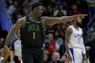 New Orleans Pelicans forward Zion Williamson (1) reacts after making a basket next to Los Angeles Clippers forward Paul George (13) during the first half of an NBA basketball game in New Orleans, Friday, March 15, 2024. (AP Photo/Matthew Hinto1