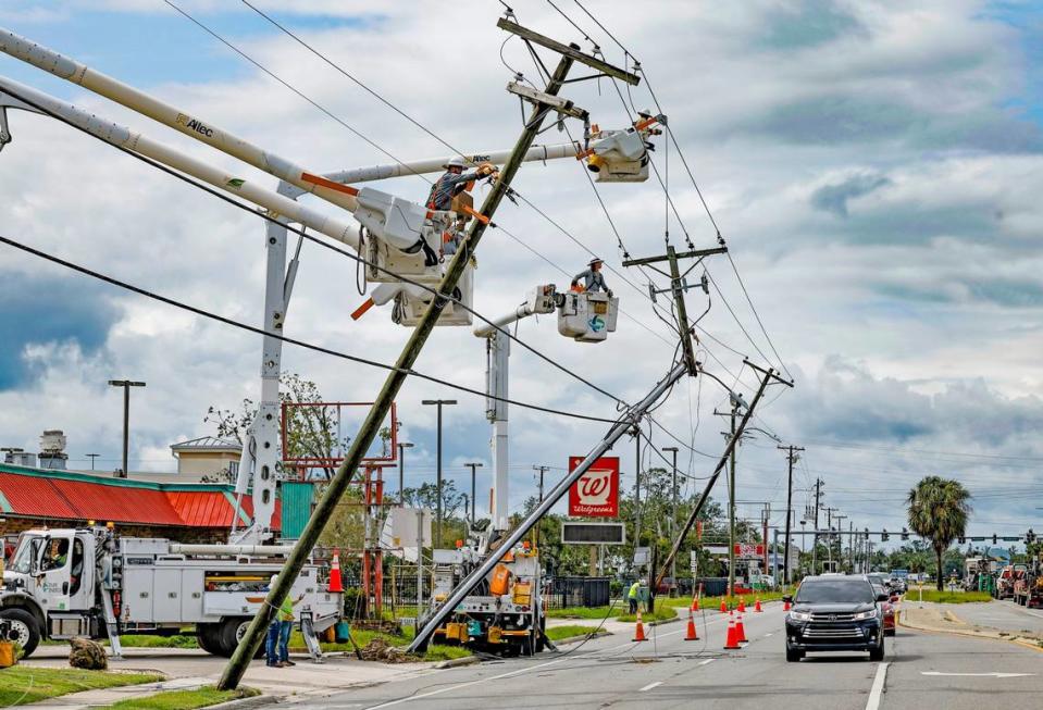 Power line repair crew members work on damaged electrical poles caused by Hurricane Idalia in Perry, Florida on Wednesday, August 30, 2023.