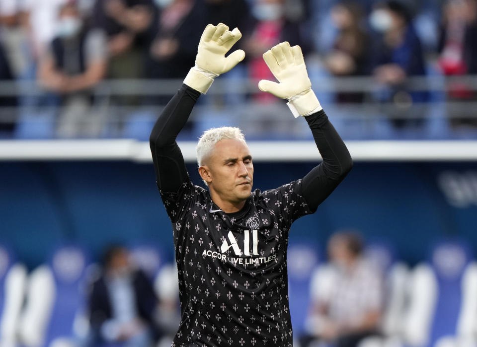 El costarricense Keylor Navas, arquero del París Saint-Germain, realiza estiramientos antes del partido de la liga francesa ante Troyes, el sábado 7 de agosto de 2021 (AP Foto/Francois Mori)