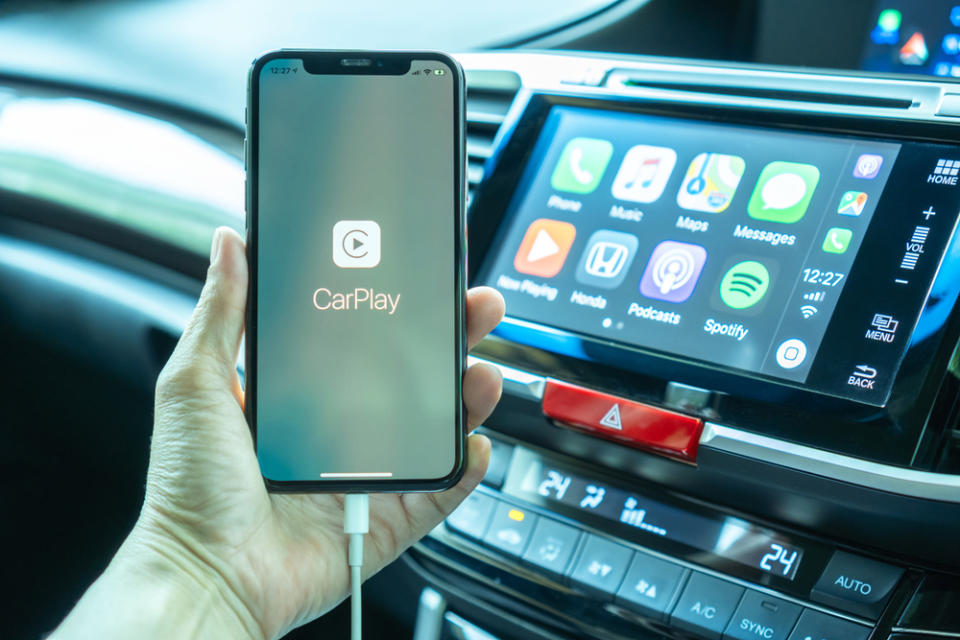 iphone plugged into car with carplay logo