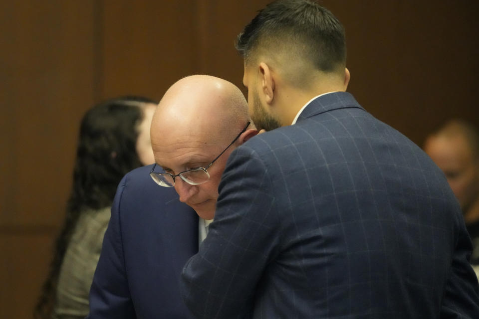 Robert E. Crimo Jr., talks to his attorney George Gomez as he appears before Judge George D. Strickland at the Lake County Courthouse, Monday, Nov. 6, 2023, in Waukegan, Ill. The father of a man charged with fatally shooting seven people at a Fourth of July parade in suburban Chicago is scheduled for a bench trial started Monday on charges that he helped his son obtain a gun license years before the attack. (AP Photo/Nam Y. Huh, Pool)