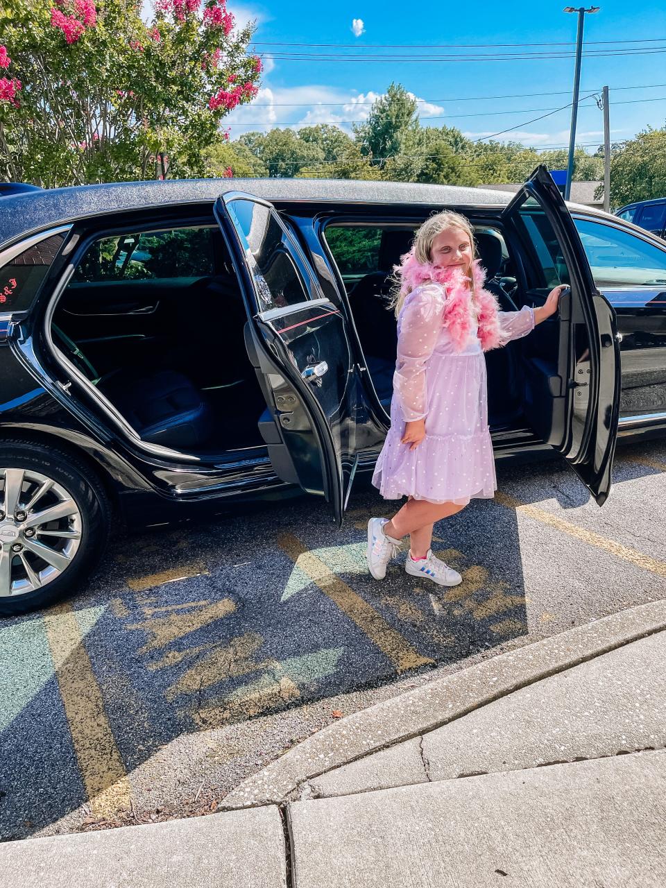 New fourth grader Calliope Young-Lutz poses next to the limo at Dogwood Elementary School’s Back to School Premiere event on Aug. 3, 2022.