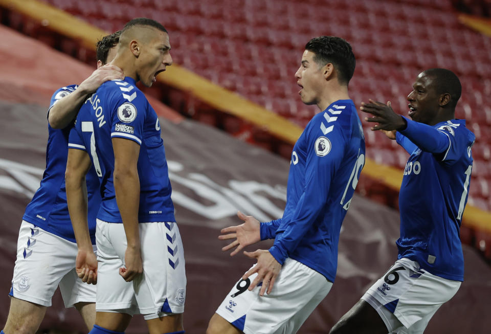 Everton's Richarlison, second left celebrates with teammates after scoring the opening goal of the game during the English Premier League soccer match between Liverpool and Everton at Anfield in Liverpool, England, Saturday, Feb. 20, 2021. (Phil Noble/ Pool via AP)