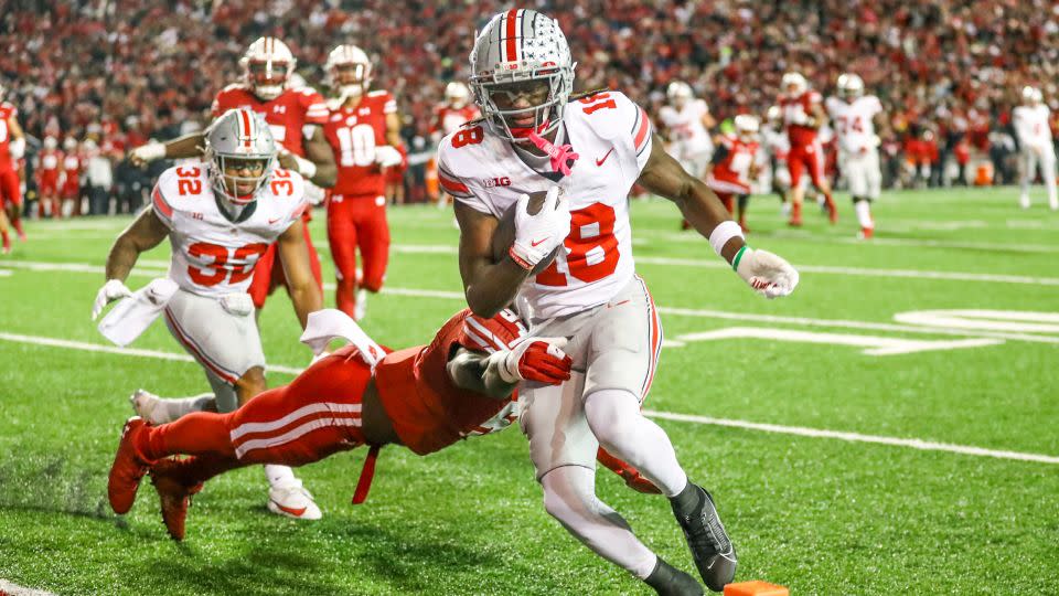 Harrison Jr. runs into the end zone for a touchdown during Ohio State's game against the University of Wisconsin Badgers. - Lawrence Iles/Icon Sportswire/AP
