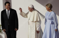 Pope Francis waves between Panamanian President Juan Carlos Varela and first lady Lorena Castillo de Varela after landing at Tocumen international airport in Panama City, Wednesday, Jan. 23, 2019. Pope Francis will be in Panama Jan. 23-27 for World Youth Day events. (AP Photo/Alessandra Tarantino)