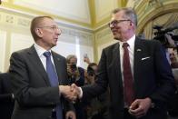 Newly elected Latvian President Edgars Rinkevics, left, shakes hands with second candidate Uldis Pilens after lawmakers elected him in the Saeima, the Latvian Parliament in Riga, Latvia, Wednesday, May 31, 2023. Latvian lawmakers on Wednesday picked the country’s long-serving and popular foreign minister, a strong backer of Ukraine, as its new head of state in a tight vote. (AP Photo/Roman Koksarov)