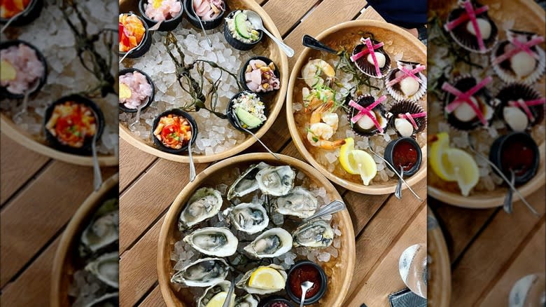 oysters, salmon tartare, ceviche, and shrimp cocktail served on ice