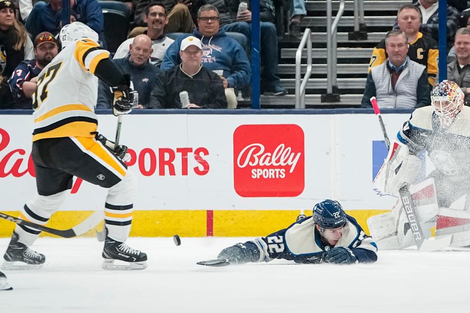 Blue Jackets defenseman Jake Bean blocks a shot from Penguins center Sidney Crosby.