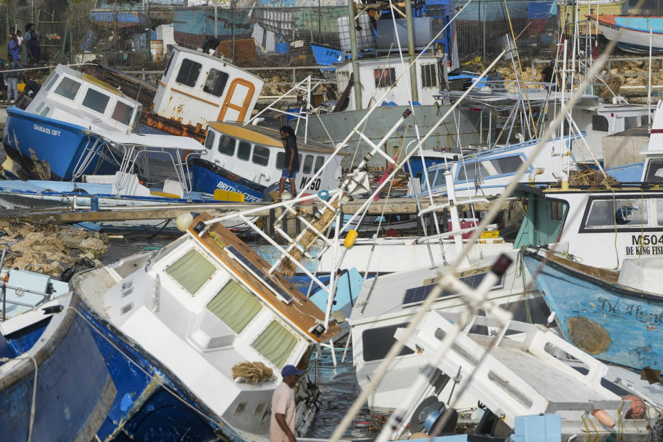 Over a dozen boats appear listing and strewn about an apparent harbor.