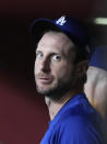 Los Angeles Dodgers' Max Scherzer talks to players in the dugout before the team's baseball game against the Arizona Diamondbacks, Saturday, July 31, 2021, in Phoenix. (AP Photo/Rick Scuteri)