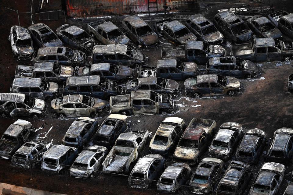 TOPSHOT - An aerial image taken on August 10, 2023 shows destroyed cars in Lahaina in the aftermath of wildfires in western Maui, Hawaii. At least 36 people have died after a fast-moving wildfire turned Lahaina to ashes, officials said August 9, 2023 as visitors asked to leave the island of Maui found themselves stranded at the airport. The fires began burning early August 8, scorching thousands of acres and putting homes, businesses and 35,000 lives at risk on Maui, the Hawaii Emergency Management Agency said in a statement. (Photo by Patrick T. Fallon / AFP) (Photo by PATRICK T. FALLON/AFP via Getty Images)