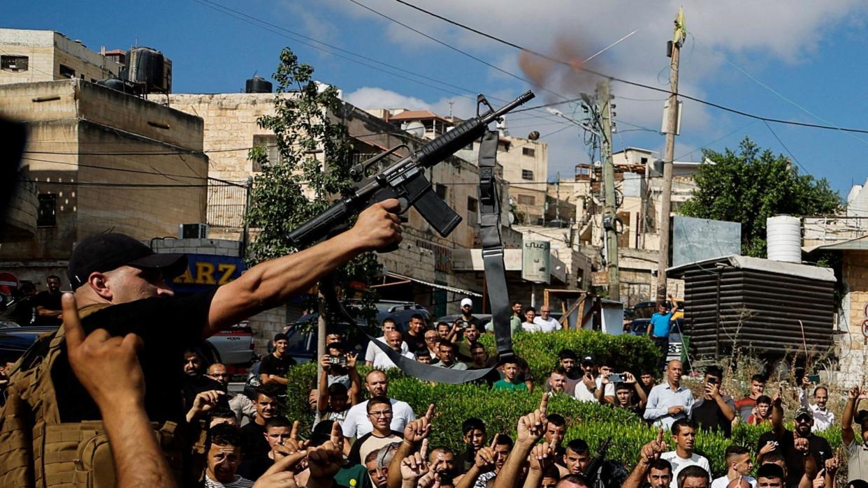 A Palestinian gunman fires into the air during the funeral for four Palestinians killed by Israeli forces, in Tubas, in the occupied West Bank (5 September 2024)