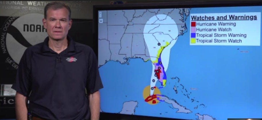 Jamie Rhome, deputy director of the National Hurricane Center, stands in front of a mockup of an experimental forecast graphic the center will add to its products later this year, in this screen grab from a virtual interview on Jan. 29.