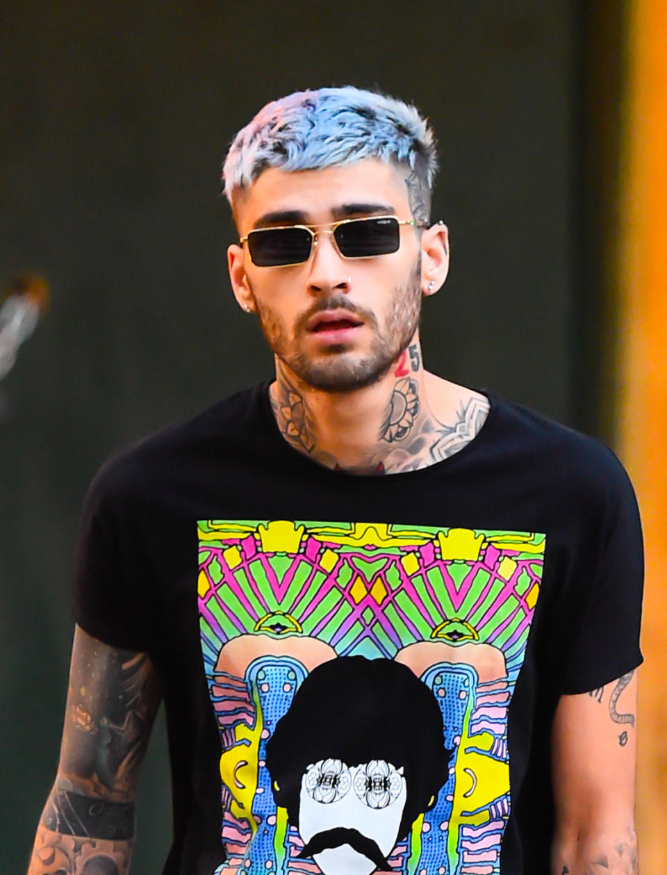 Close-up of Zayn wearing a T-shirt and sunglasses