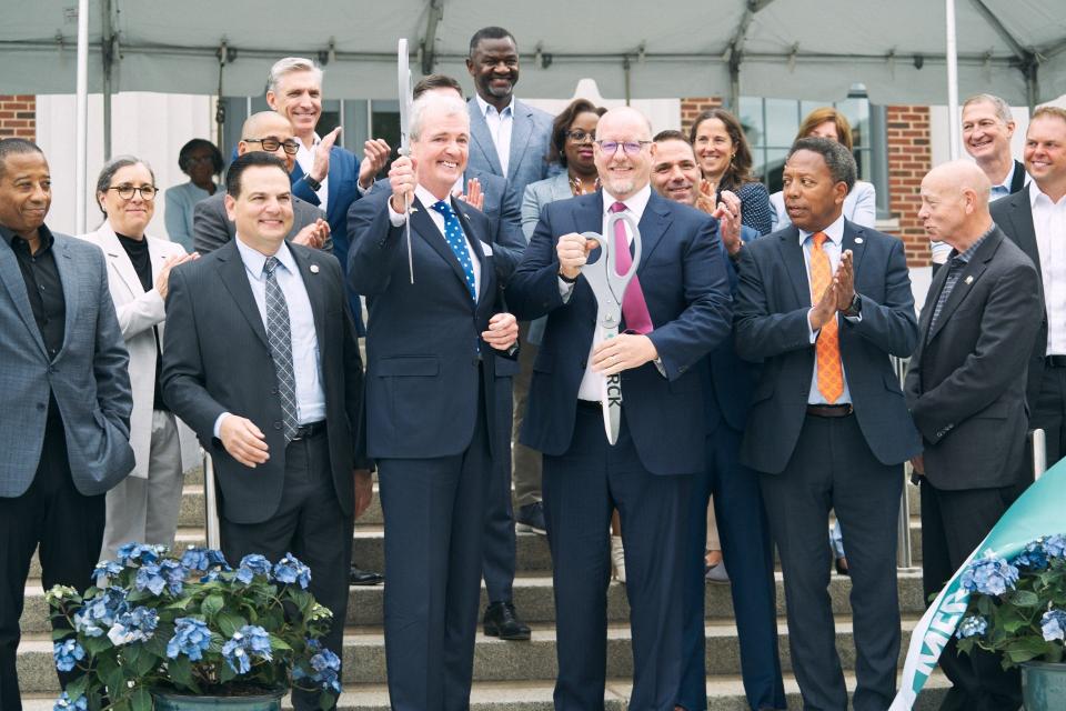 N.J. Gov. Phil Murphy and Merck Chairman & CEO Rob Davis participate in the ribbon cutting of the reimagined Merck headquarters in Rahway.