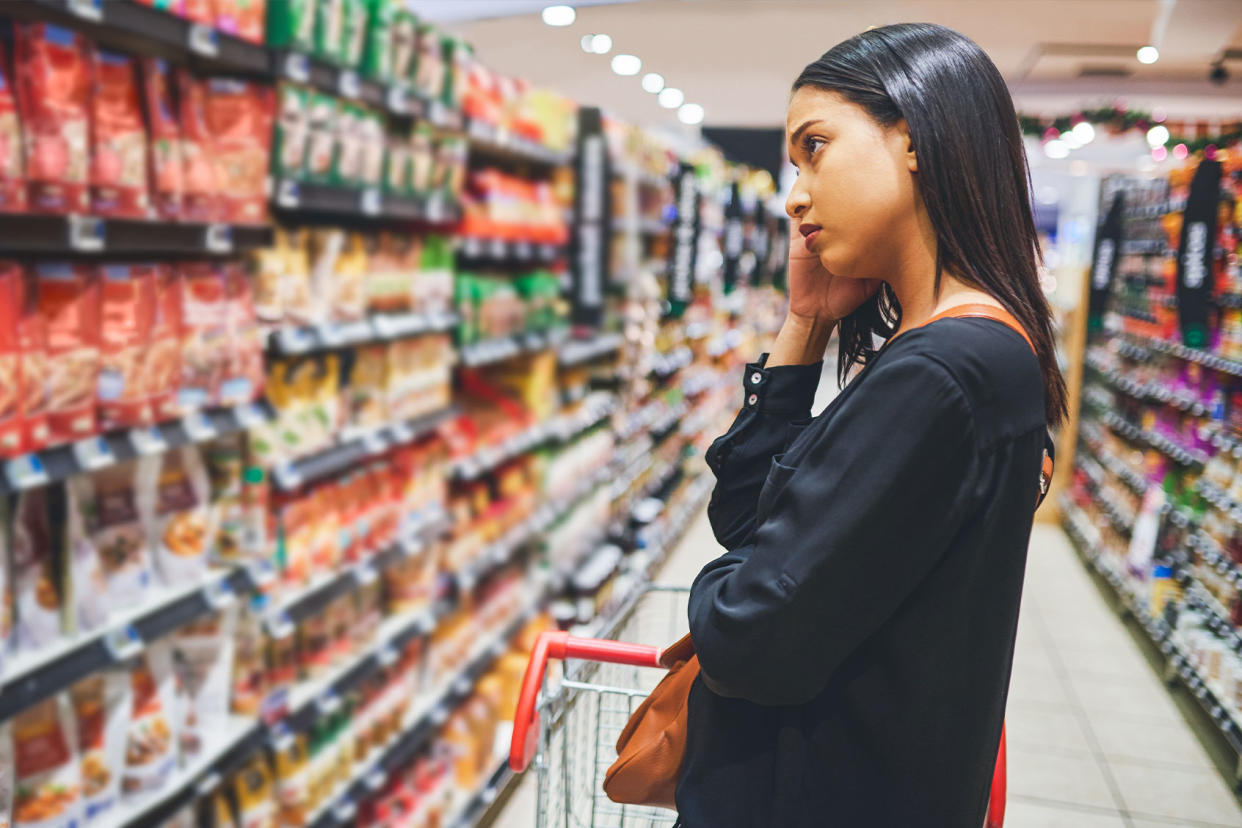 Woman shopping in a grocery store Getty Images/Moyo Studio