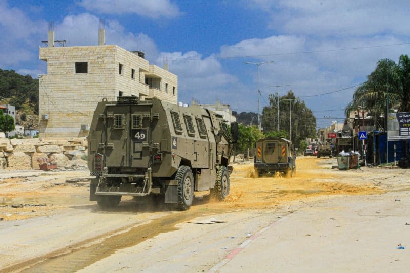 Israeli military units drive through the Nour Shams refugee camp. The operation lasted more than 24 hours. The Israeli armed forces have killed more than five Palestinians and injured dozens during their raid in the Palestinian refugee camp Nour Shams. Nasser Ishtayeh/SOPA Images via ZUMA Press Wire/dpa