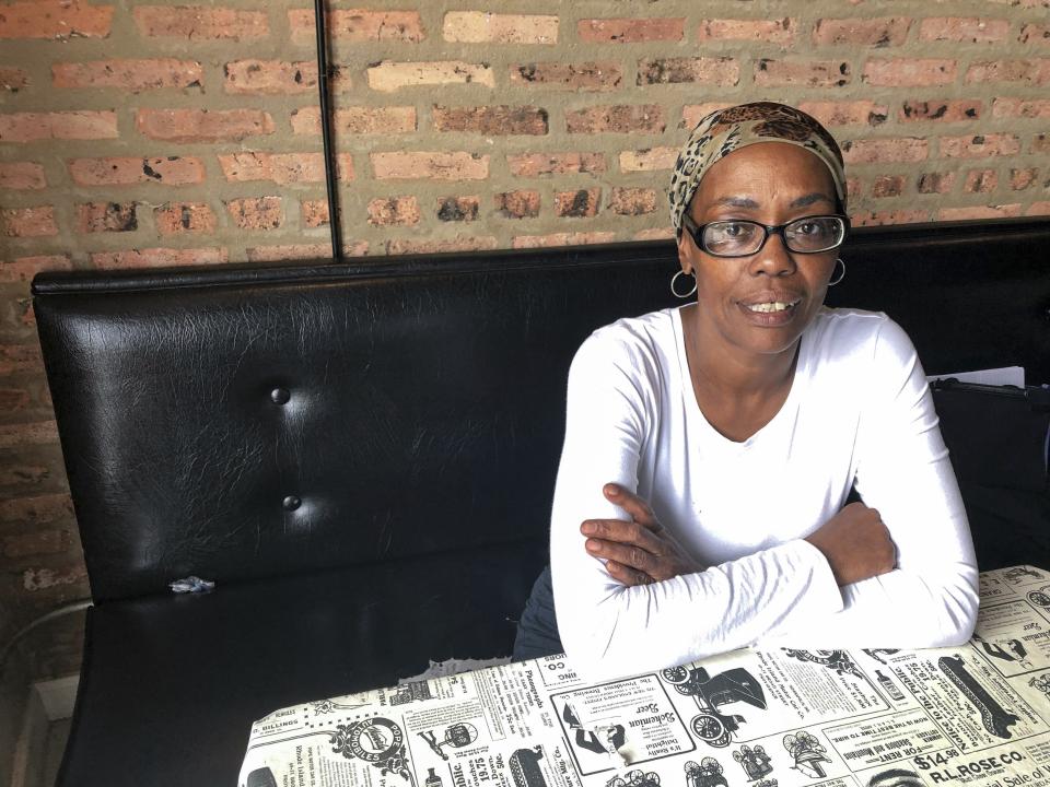 In this Thursday, June 13, 2019 photo, Tara Madison, 52, poses for a portrait at a café in Chicago. Madison is excited about the Obama Library but fears development around it will displace her and others in the South Side neighborhood of Woodlawn. (AP Photo/Sophia Tareen)