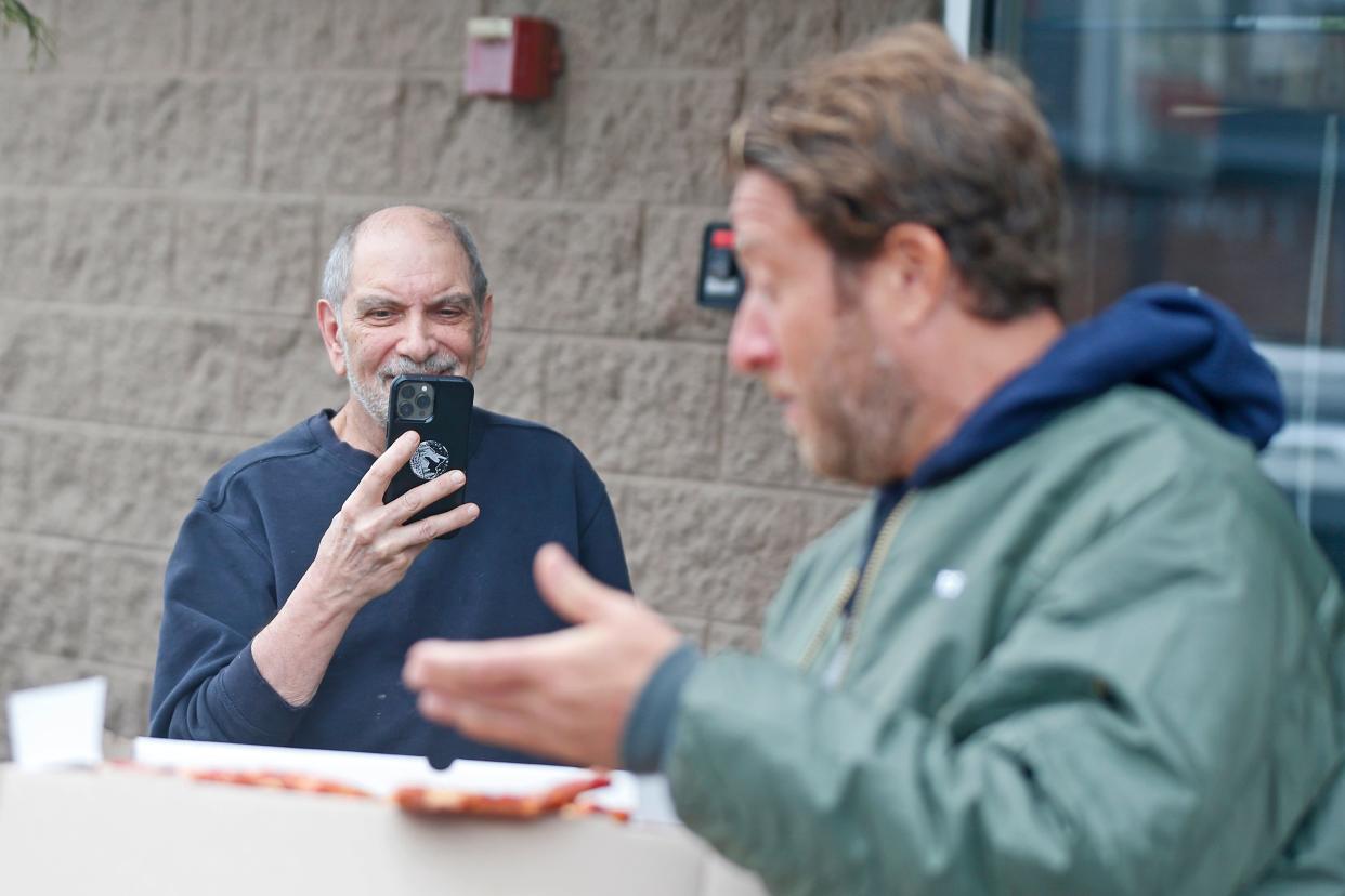 Stephen Palmieri, owner of D. Palmieri's in Johnston, busts out his cell phone during Dave Portnoy's review of the restaurant Thursday afternoon.