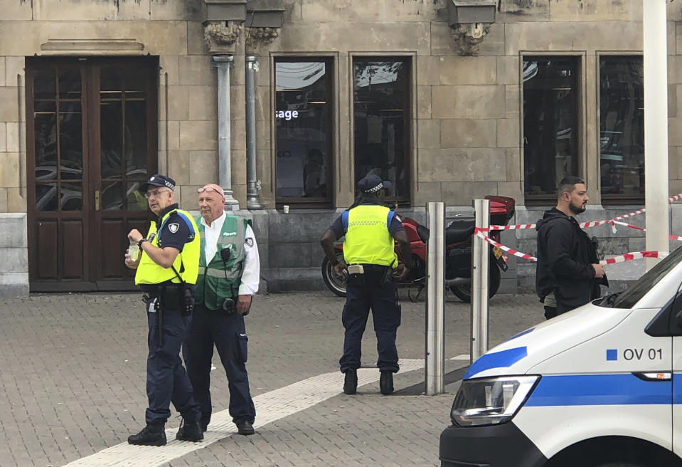 Dutch police officers near the scene of a stabbing attack near the central daily station in Amsterdam, the Netherlands, Friday Aug. 31, 2018. Police the Dutch capital shot and wounded a suspect Friday following a stabbing at the central railway station. Amsterdam police said in a series of tweets that two people were injured in the stabbing and the suspect was then shot by officers. (AP Photo/Alex Furtula)