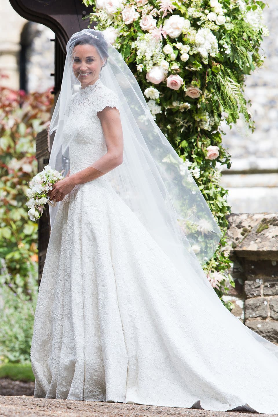 <p>Pippa wore a custom Giles Deacon wedding gown with short sleeves that showed off her crazy-toned arms. The high lace neck and train drew comparisons to older sister Kate's 2011 wedding gown.</p><p><strong>RELATED</strong>: <a href="https://www.goodhousekeeping.com/life/news/g4368/pippa-middleton-wedding-photos/" rel="nofollow noopener" target="_blank" data-ylk="slk:Pippa Middleton's Wedding in Photos;elm:context_link;itc:0;sec:content-canvas" class="link ">Pippa Middleton's Wedding in Photos</a></p>