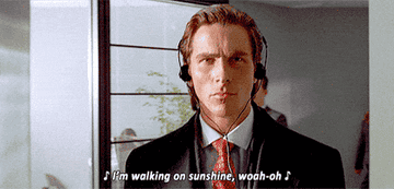 Christian Bale walking with headphones in "American Psycho"