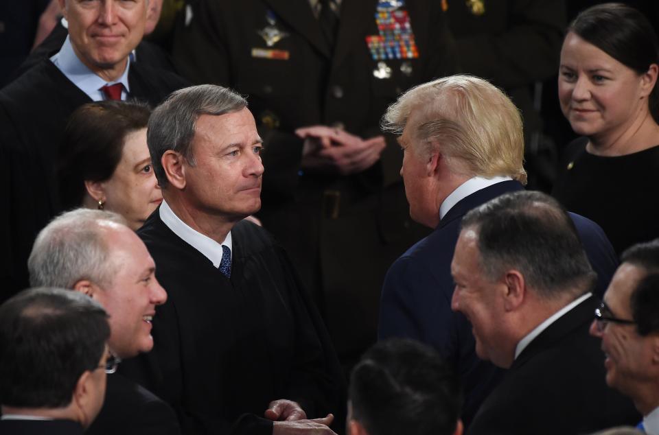 Donald Trump greets Supreme Court Chief Justice John Roberts as the president arrives to deliver the State of the Union address on Feb. 4, 2020. Trump's promise to name conservative judges secured his support from Republican leaders in 2016. (Photo: OLIVIER DOULIERY/AFP via Getty Images)