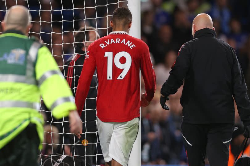 Manchester United's French defender Raphael Varane (C) leaves the pitch