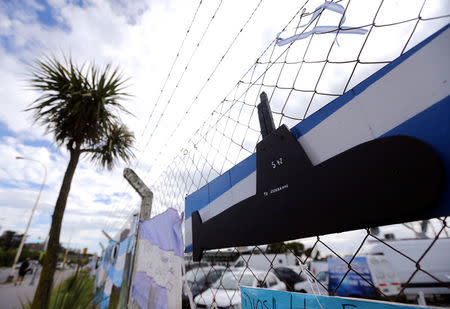 Signs with messages in support of the 44 crew members of the missing at sea ARA San Juan submarine are seen placed on a fence at an Argentine naval base in Mar del Plata, Argentina November 22, 2017. Words on the flag read "We are with you". REUTERS/Marcos Brindicci