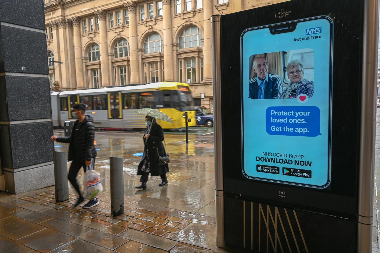 An electronic sign reminds pedestrians to download the NHS Test and Trace app, which has also been heavily criticised  (AFP via Getty Images)