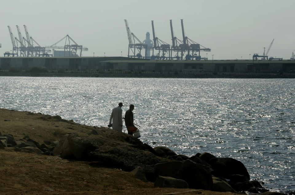 Visitors prepare to fish in front of the Red Sea port, in Jiddah, Saudi Arabia, Monday, Dec.14, 2020. An explosion rocked a ship off Saudi Arabia's port city of Jiddah on the Red Sea, authorities said Monday, without elaborating. (AP Photo/Amr Nabil)