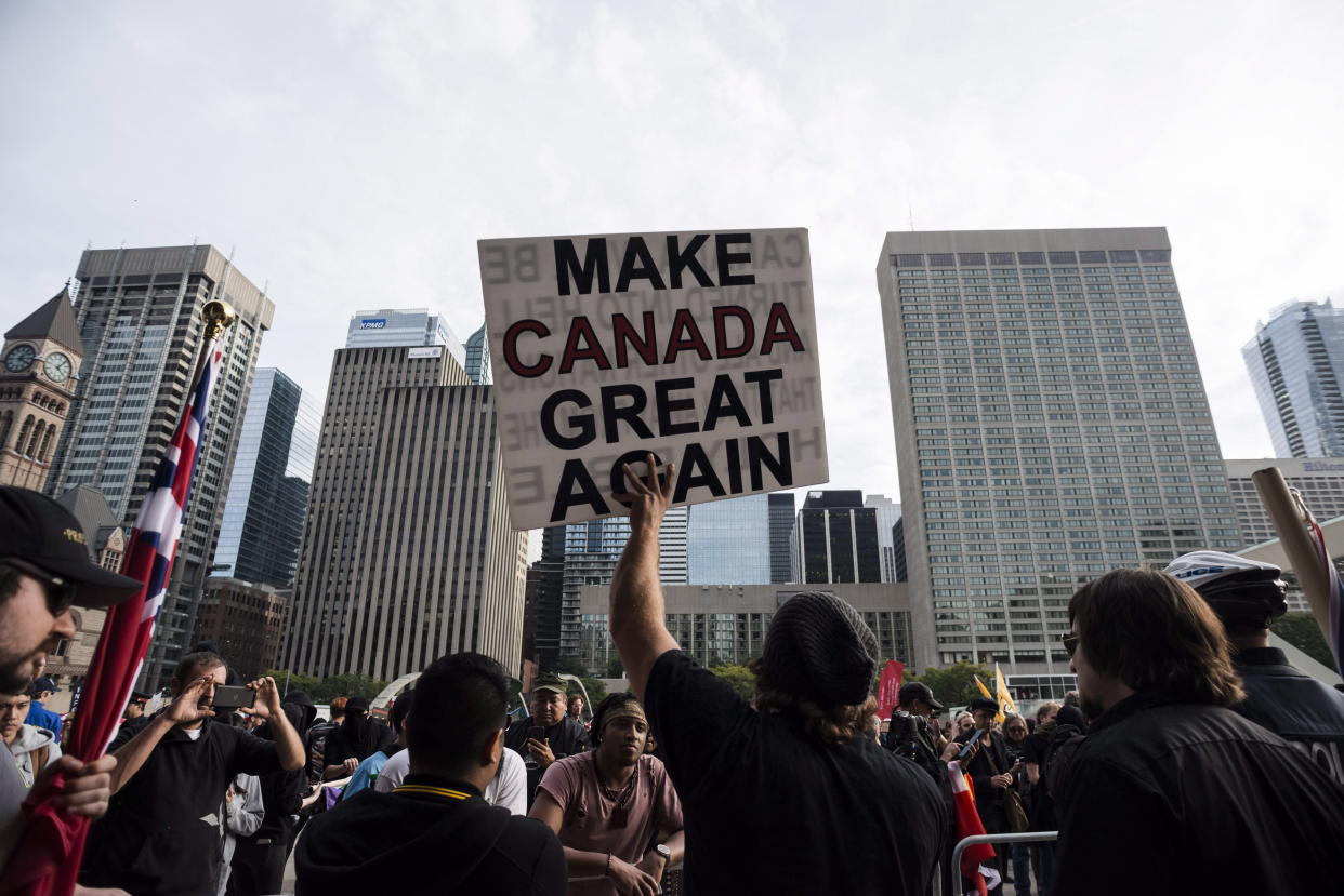 Far-right and ultra-nationalist groups, including the Northern Guard, Proud Boys, and individuals wearing Soldiers of Odin patches, were among those gathered to protest the government's lawsuit settlement with Canadian torture victim Omar Khadr, at Nathan Philips Square in Toronto on Saturday, October 21, 2017. THE CANADIAN PRESS/Christopher Katsarov