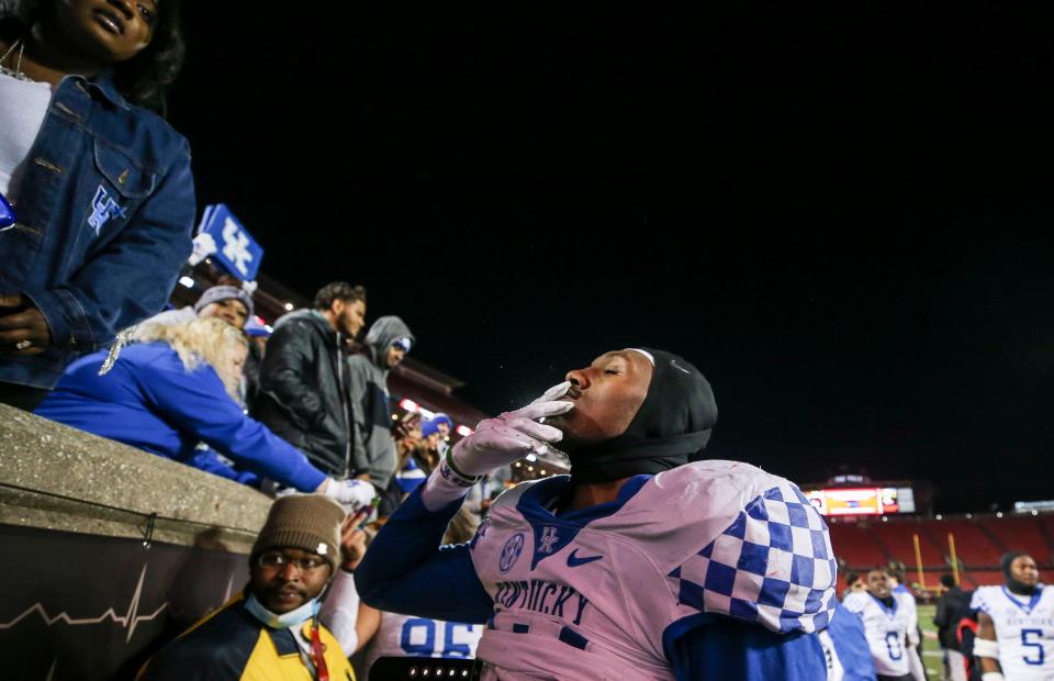 Kentucky's J.J. Weaver blew a kiss to his family after the Wildcats rolled past Louisville, 52-21, on Nov. 27, 2021. "This is my city," said Weaver, who graduated from Moore High School.