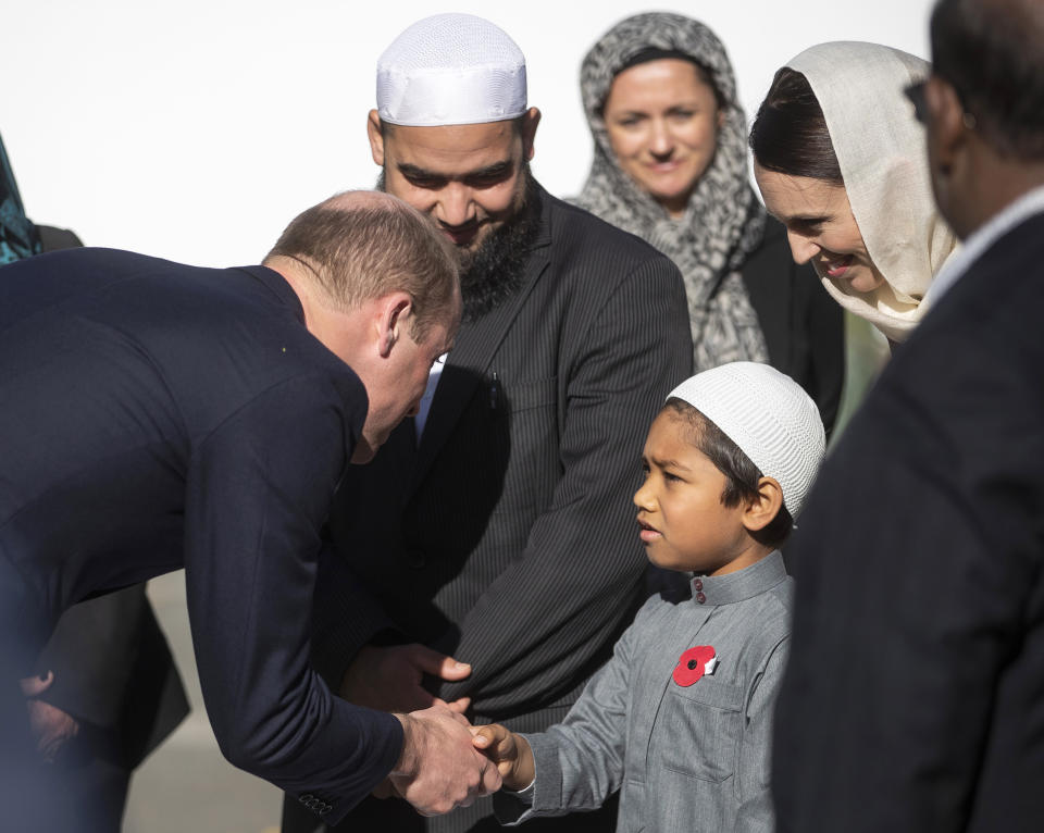 Britain's Prince William, left, meets a young Muslim community member and New Zealand Prime Minister Jacinda Ardern, second right, at the Al Noor mosque during a visit to the mosque in Christchurch, New Zealand, Friday, April 26, 2019. Prince William visited the one of the mosques where 50 people were killed and 50 others wounded in a March 15 attack by a white supremacist. (Joseph Johnson/Pool via AP)