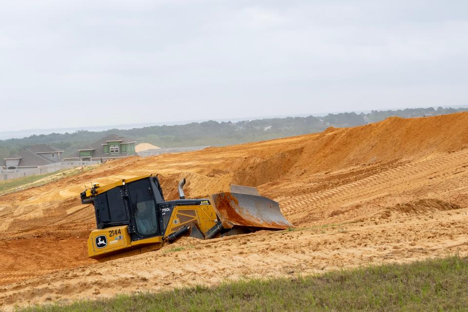 A bulldozer is shown clearing land for a new development in the Hills of Minneola area on April 11.