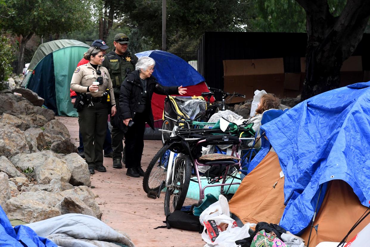 Sister Lisa Megaffin, of the Sisters of Notre Dame, greets Dylan Sjostrom, 29, in Thousand Oaks during the 2024 homeless count in January. The results from the survey shows homelessness is down in Ventura County.