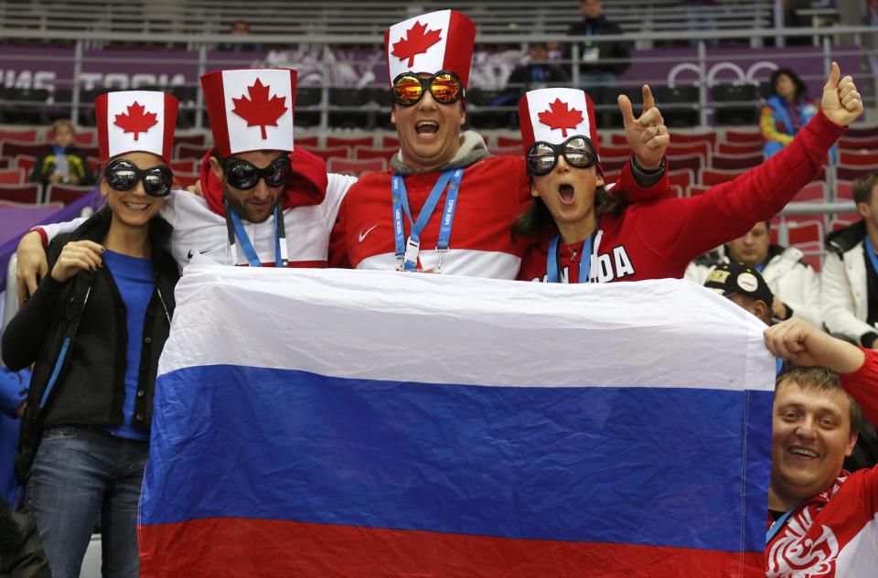 Team Canada fans await the start of the men's preliminary round ice hockey game against Norway at the Sochi 2014 Sochi Winter Olympics, February 13, 2014. REUTERS/Mark Blinch (RUSSIA - Tags: OLYMPICS SPORT ICE HOCKEY)