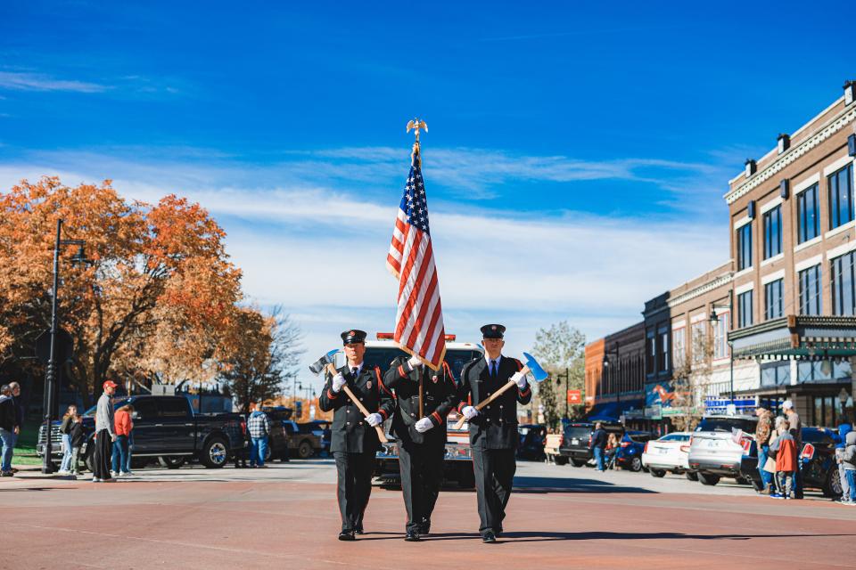 The Firemen Honor Guard leads the Veterans Day Parade in downtown Bartlesville on Saturday