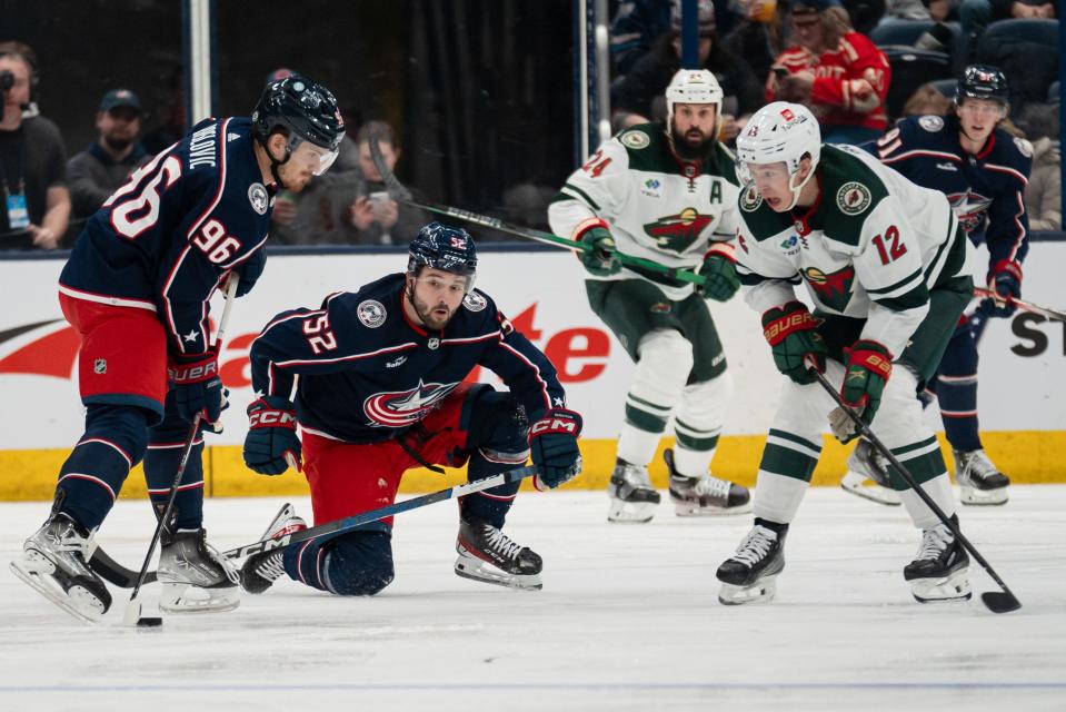 Jan 6, 2024; Columbus, Ohio, USA;
Columbus Blue Jackets center Jack Roslovic (96) looks for a shot or a pass around Minnesota Wild left wing Matt Boldy (12) during the second period of their game on Saturday, Jan. 6, 2024 at Nationwide Arena.