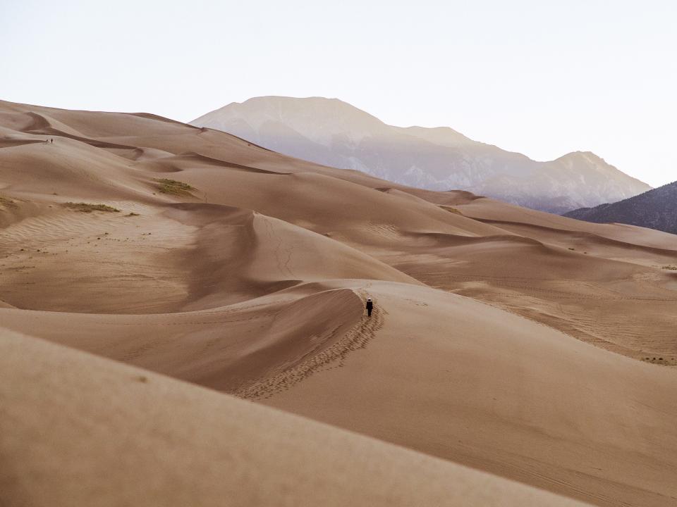 Person Walking in the Distance on a Sand Dune in the Desert at Sunrise  Matt Pirrall/Getty Images