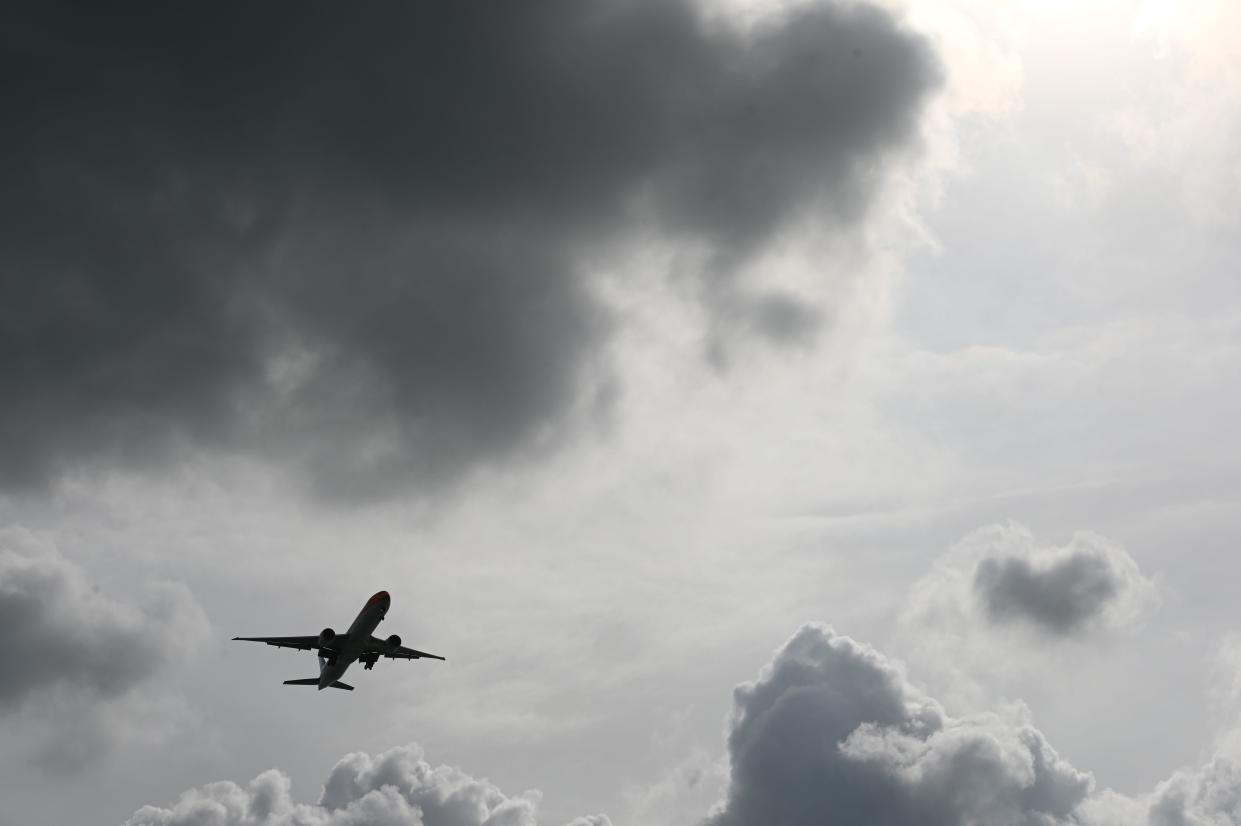 A passenger plane approaches for landing at Changi International Airport in Singapore on December 19, 2020. (Photo by Roslan RAHMAN / AFP) (Photo by ROSLAN RAHMAN/AFP via Getty Images)