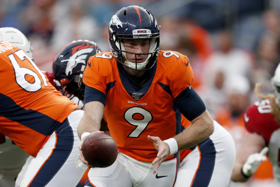 Denver Broncos quarterback Kevin Hogan (9) hands off against the Arizona Cardinals during the first half of an NFL preseason football game, Thursday, Aug. 29, 2019, in Denver. (AP Photo/David Zalubowski)