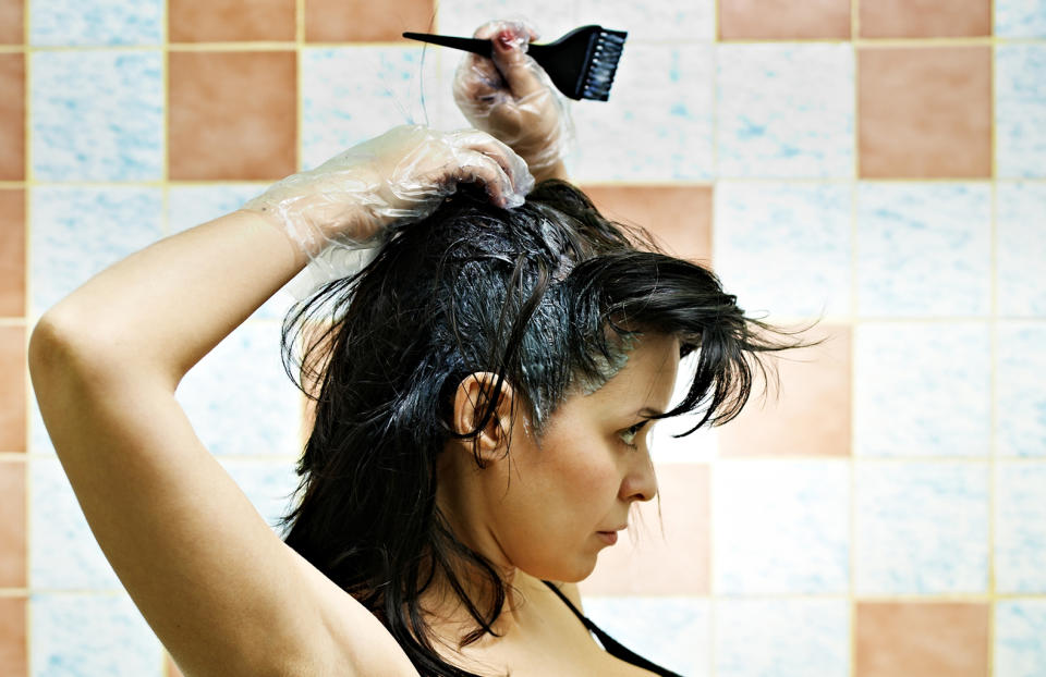 Use dark or old towels and wear dark clothing when dyeing your hair because dyes stain fabric. (Photo: Getty Images)